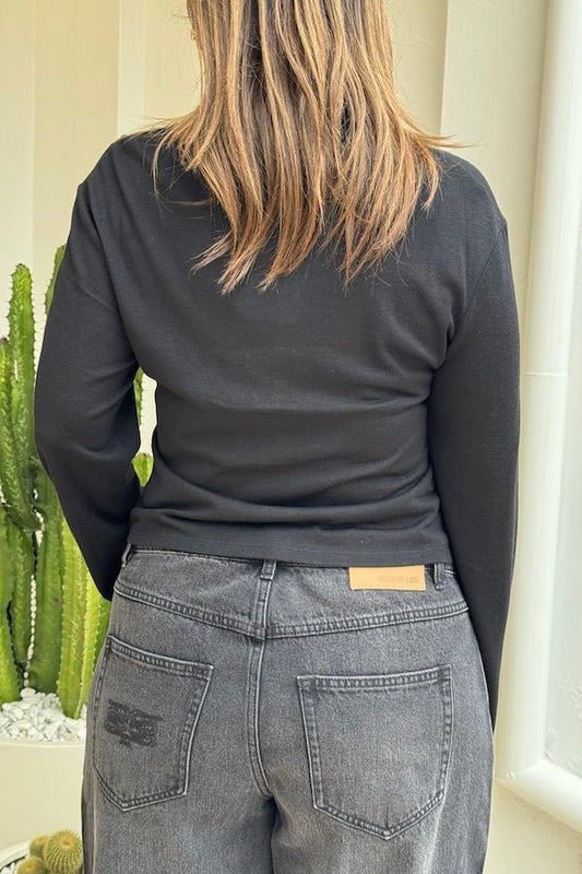 Anya Long Sleeve Top Black by Sneaky Link — Soft knit blend with a relaxed fit, classic collar, and button neck opening. Perfect for layering or pairing with denim. Dry clean only.