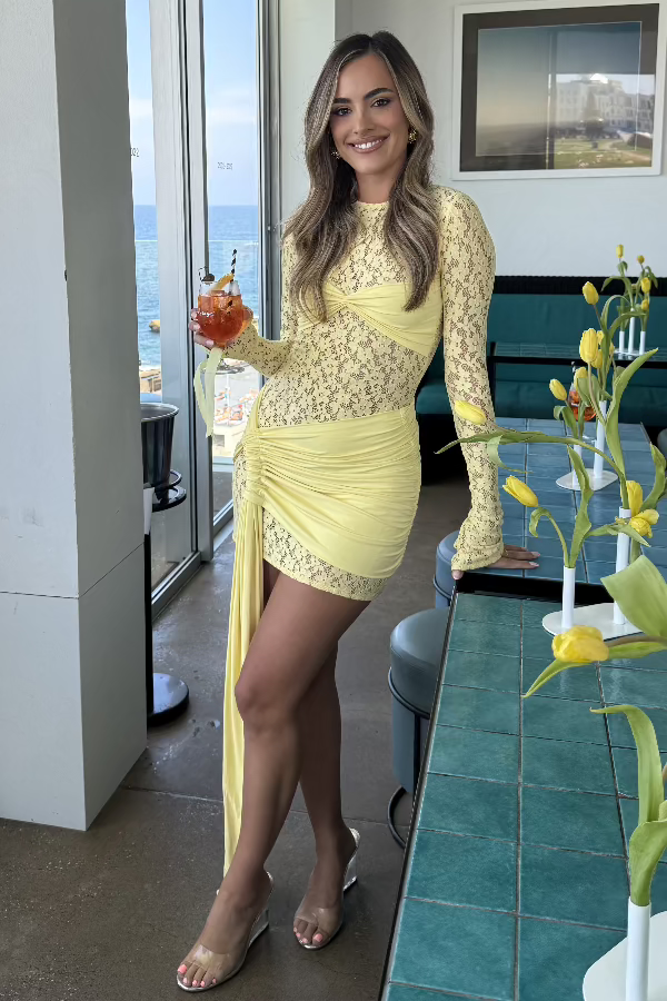 Ortigia Baby Yellow by Decon Duarte – A vibrant sheer stretch lace dress with a fully backless design and adjustable mini skirt. Perfect for standout seasonal events.