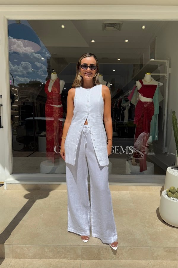 Mia Mini Dress White by Sneaky Link – A trendy, breathable linen dress with a high scoop neckline and button front, perfect for effortless summer days.