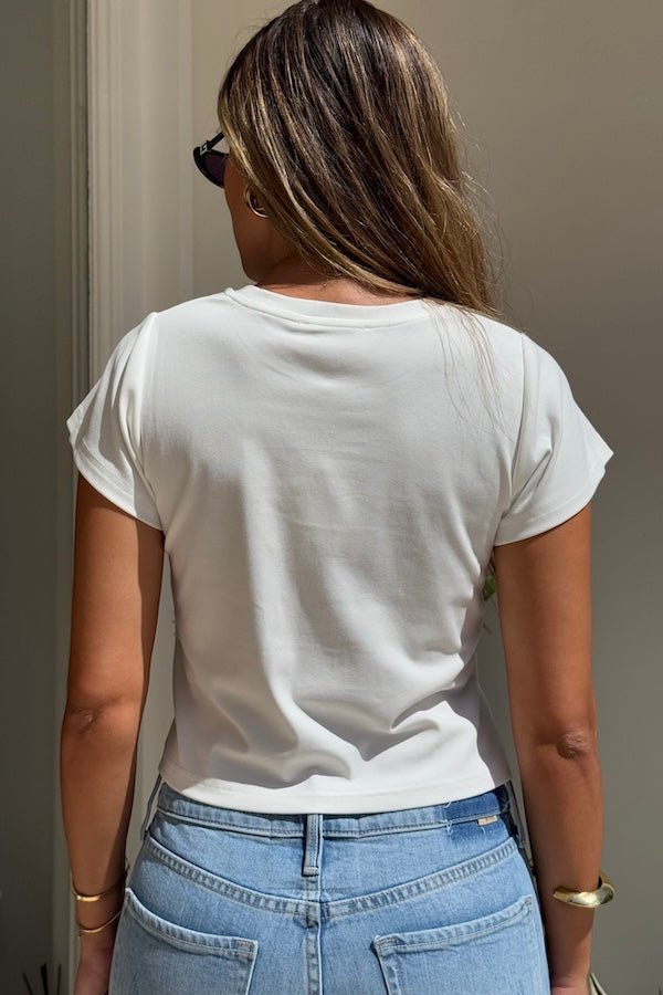 Claudia Baby Tee White by Sneaky Link – A relaxed, cropped tee crafted from a soft viscose-spandex blend for comfort and stretch. Perfect casual chic with short sleeves.