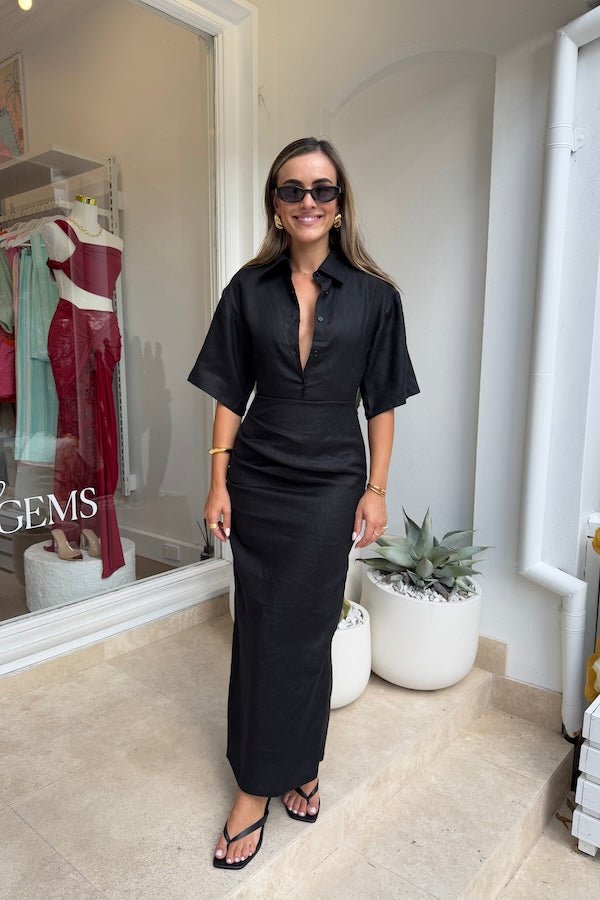 Lefka Midi Dress Black by Sneaky Link – A breathable 100% linen midi with button-front and flattering tucks, offering relaxed elegance perfect for sunny days and casual outings.