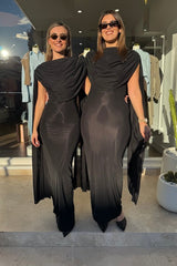 Batista Basalto by Maygel Coronel – An elegant long dress with a cowl scoop neckline, flowing shoulder sashes, and a sleek column silhouette, perfect for sophisticated evening events and making a timeless, statuesque statement.