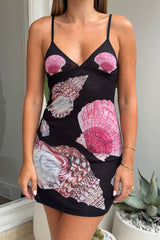 Ariel Mini Dress Black Shell by Sneaky Link – Trendy and flirty, this lightweight printed mesh mini features a custom hand-painted shell design, adjustable straps, and a flattering V-neckline, perfect for standout events with playful sophistication.
