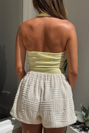 Bella Halter Tank Lemon by Sneaky Link – Soft cotton-spandex tank with deep scoop neckline and open back. A trendy, breathable piece for viral summer vibes.