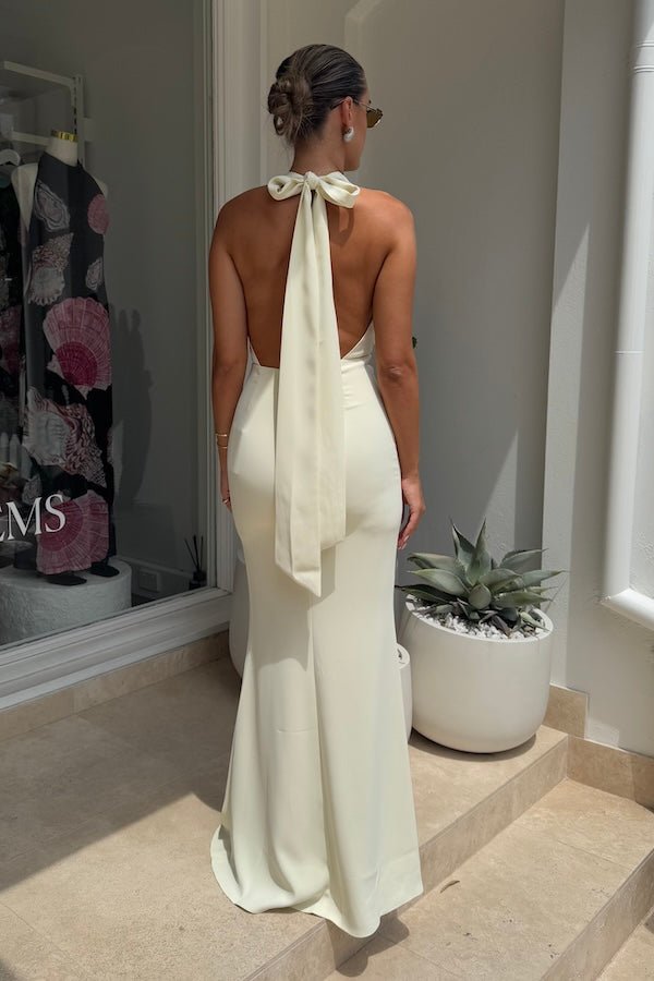 The Ultimate Muse Tie Neck Maxi Dress Butter Cream by Odd Muse – A viral bridal favorite featuring a flattering V-neck, draped shoulders, and elegant low back, perfect for all-night celebrations.