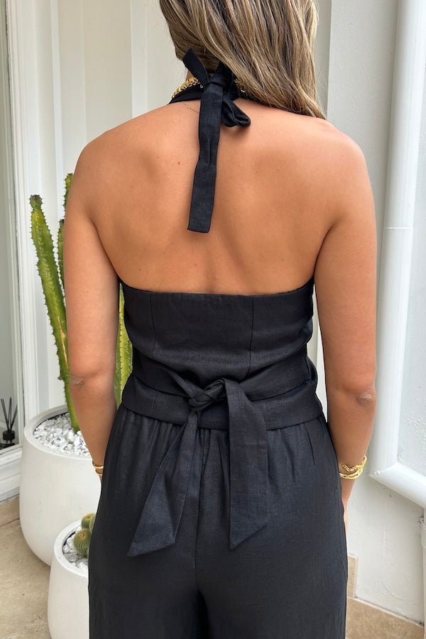 Luna Linen Vest Black by Sneaky Link – Chic 100% linen halterneck vest with adjustable tie neck and back, elasticated detail, and front buttons, perfect for stylish summer layering with shorts, skirts, or denim.