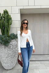 Lottie Long Sleeve Top White by Sneaky Link – Soft cotton blend with scoop neckline and snap button detail. Perfect for chic layering and viral winter style.