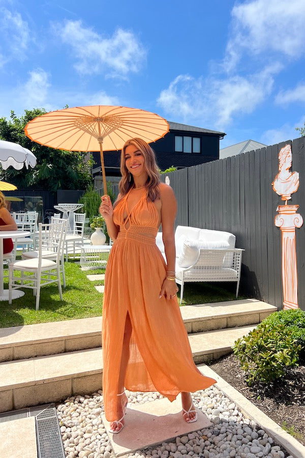 Artemis Dress Apricot by D'Artemide – Cotton halterneck dress with cutout detailing and front split for a bold, stylish look.