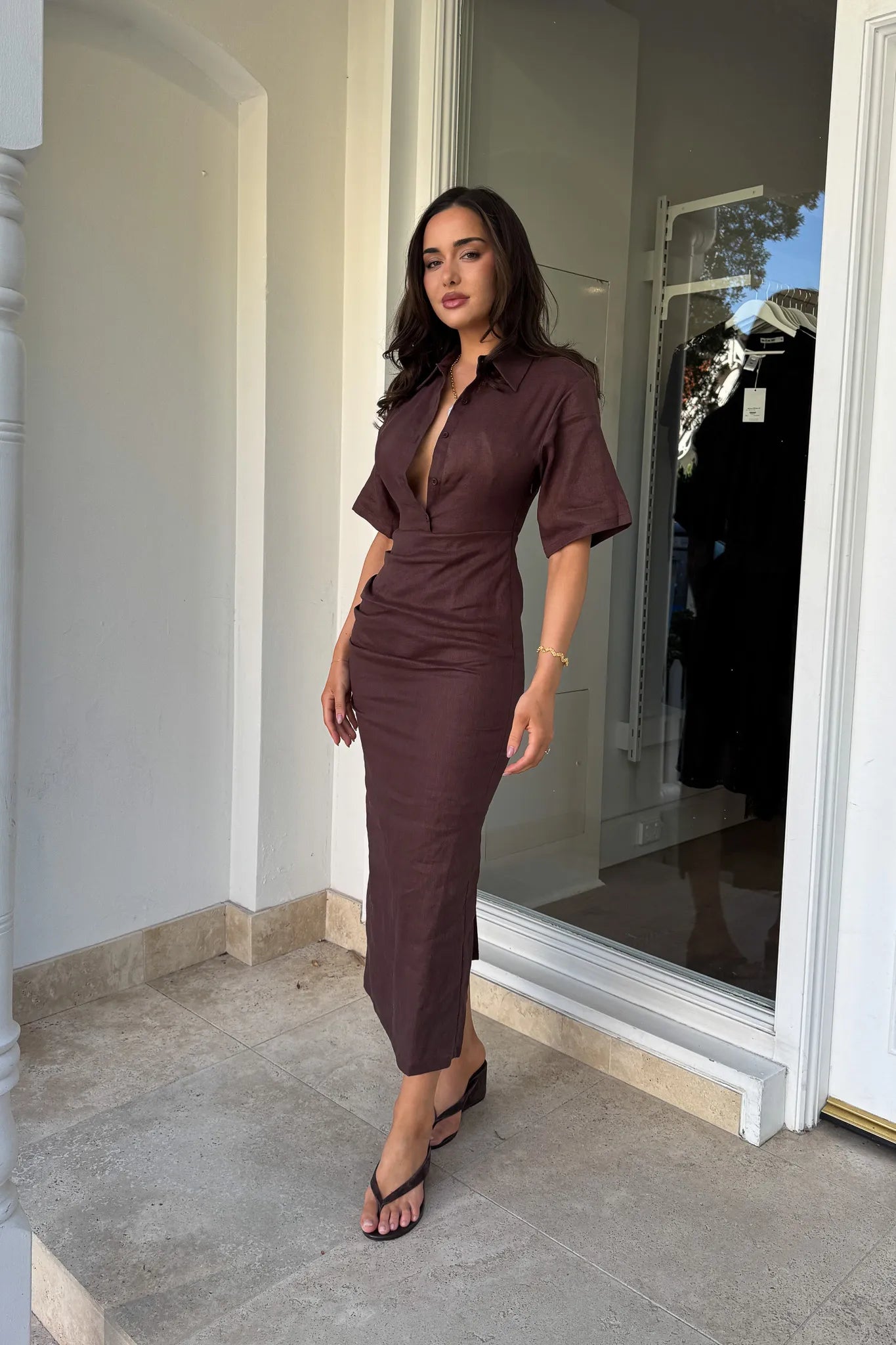 Lefka Midi Dress Chocolate by Sneaky Link – A trendy, breathable linen midi with flattering skirt tucks and button-front neckline, perfect for sunny lunches and relaxed summer days.