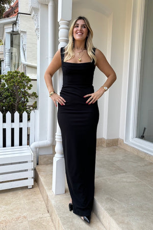 Marbella Gown Black by Effie Kats – A sleek black gown with bustier-inspired bodice, draped detail, and split hem for graceful movement.