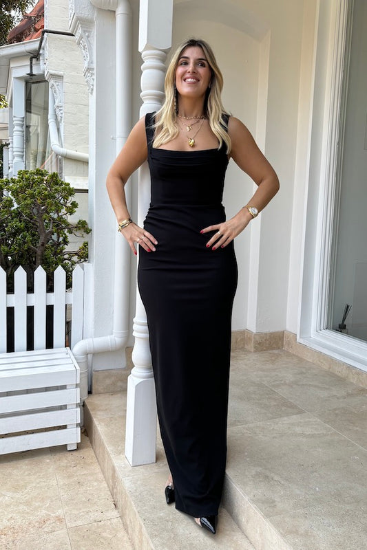 Marbella Gown Black by Effie Kats – A sleek black gown with bustier-inspired bodice, draped detail, and split hem for graceful movement.