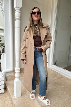 Evans Trench Coat Sand by Camilla and Marc — Oversized twill trench with double-breasted front, epaulettes, belt, and recycled polyester lining. Dry clean only.