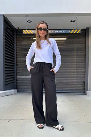 Long Sleeve Tee White by Sneaky Link – The ultimate capsule piece, this loose-fit 100% cotton tee is perfect for everyday wear. Lia wears M, Renee wears XS.
