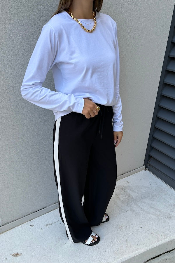 Long Sleeve Tee White by Sneaky Link – The ultimate capsule piece, this loose-fit 100% cotton tee is perfect for everyday wear. Lia wears M, Renee wears XS.