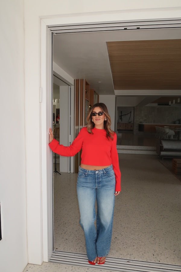 The Dodger Button Sneak Wipeout by MOTHER, trendy mid-blue jeans with a slouchy fit, loose straight leg, and a clean hem. Perfect for a relaxed look with whiskering and knee fading, made from rigid SUPERIOR denim.