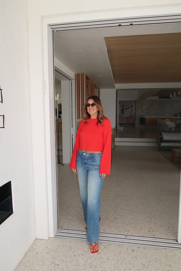 The Dodger Button Sneak Wipeout by MOTHER, trendy mid-blue jeans with a slouchy fit, loose straight leg, and a clean hem. Perfect for a relaxed look with whiskering and knee fading, made from rigid SUPERIOR denim.