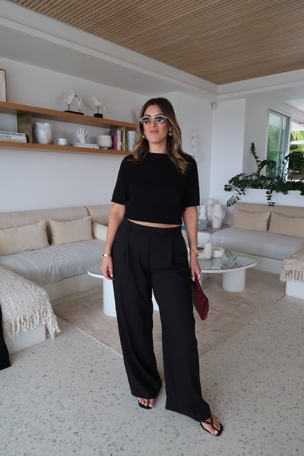 Kate Tailored Pant Black by Sneaky Link, high-waisted wide-leg pants crafted from luxe suiting fabric. Features waist tucks, pockets, and crossed belt loops for a modern, polished look.