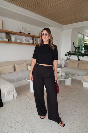 Niamh Knit Top Black by Sneaky Link – A chic cropped knit with a high scoop neckline and ribbed details. Perfectly blends comfort and style for versatile daywear.