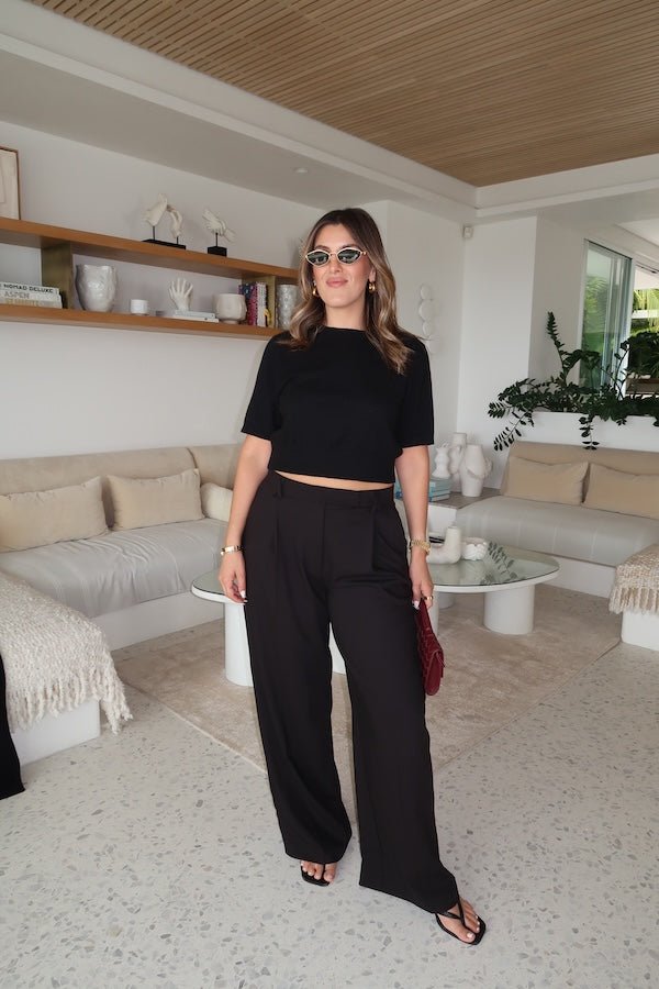 Niamh Knit Top Black by Sneaky Link – A chic cropped knit with a high scoop neckline and ribbed details. Perfectly blends comfort and style for versatile daywear.