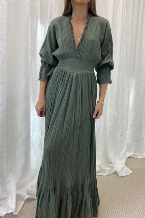 Eleni Dress Khaki by D'Artemide – One-size cotton dress with ruched waist, V neckline, and maxi skirt for chic all-day wear.