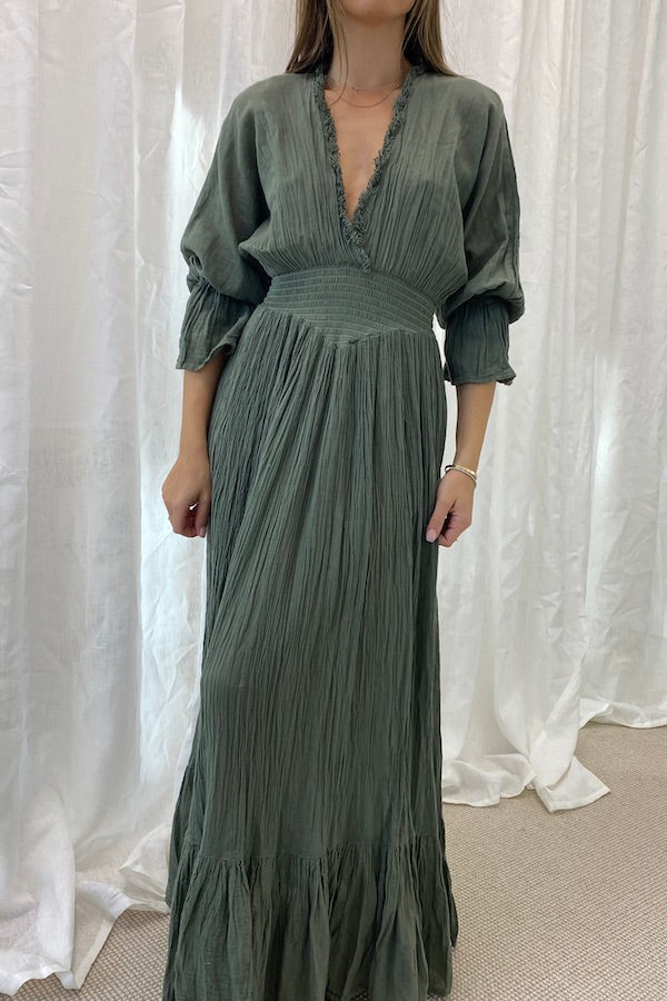 Eleni Dress Khaki by D'Artemide – One-size cotton dress with ruched waist, V neckline, and maxi skirt for chic all-day wear.