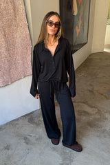 The Hunter Long Sleeve Polo Top in Black by Sneaky Link is a soft second skin essential with a flattering fit, polished collar, and easy everyday appeal.