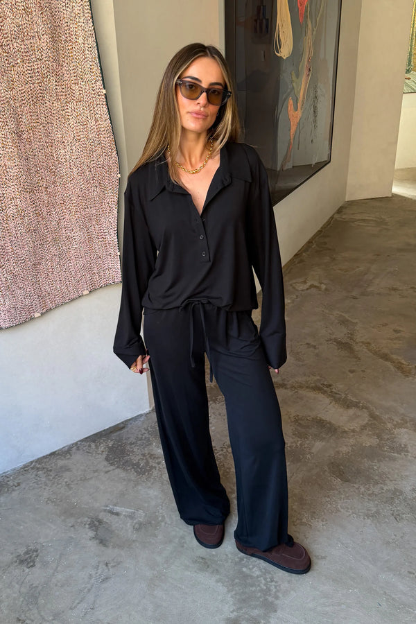 The Hunter Long Sleeve Polo Top in Black by Sneaky Link is a soft second skin essential with a flattering fit, polished collar, and easy everyday appeal.