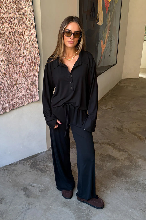 The Hunter Long Sleeve Polo Top in Black by Sneaky Link is a soft second skin essential with a flattering fit, polished collar, and easy everyday appeal.