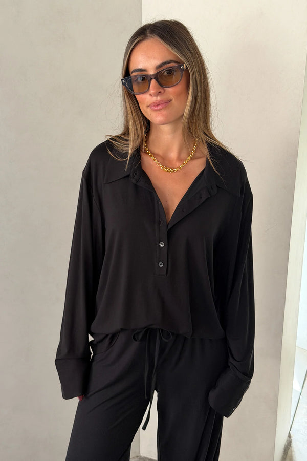 The Hunter Long Sleeve Polo Top in Black by Sneaky Link is a soft second skin essential with a flattering fit, polished collar, and easy everyday appeal.