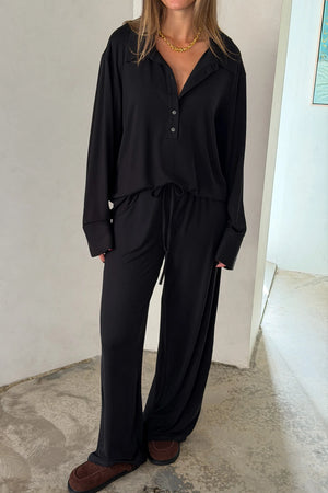 The Hunter Long Sleeve Polo Top in Black by Sneaky Link is a soft second skin essential with a flattering fit, polished collar, and easy everyday appeal.