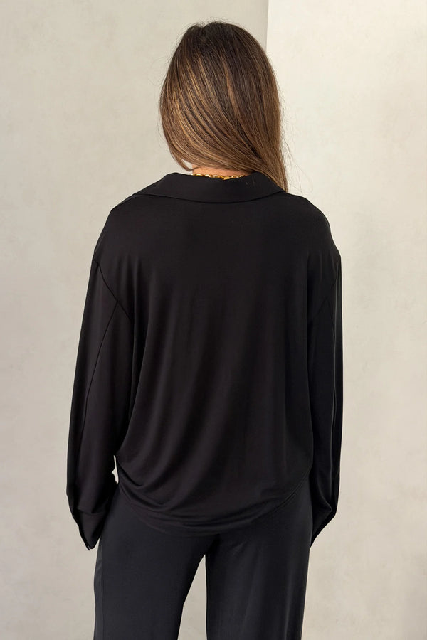 The Hunter Long Sleeve Polo Top in Black by Sneaky Link is a soft second skin essential with a flattering fit, polished collar, and easy everyday appeal.