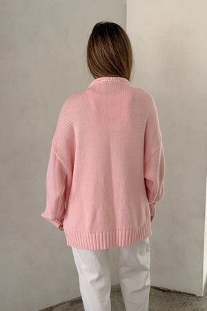 The Loren Oversized Knit Cardigan in Pink by Sneaky Link features a soft cotton wool knit, relaxed oversized fit, and cosy drape that layers effortlessly over everyday outfits.