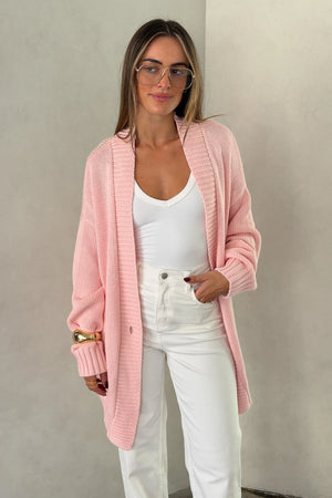 The Loren Oversized Knit Cardigan in Pink by Sneaky Link features a soft cotton wool knit, relaxed oversized fit, and cosy drape that layers effortlessly over everyday outfits.