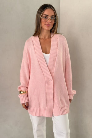 The Loren Oversized Knit Cardigan in Pink by Sneaky Link features a soft cotton wool knit, relaxed oversized fit, and cosy drape that layers effortlessly over everyday outfits.