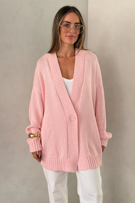 The Loren Oversized Knit Cardigan in Pink by Sneaky Link features a soft cotton wool knit, relaxed oversized fit, and cosy drape that layers effortlessly over everyday outfits.