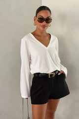 The Carter V Neck Long Sleeve Top by Sneaky Link is a breathable 100% cotton essential with a flattering V neckline and easy fit that pairs effortlessly with denim, tailoring, or layers.