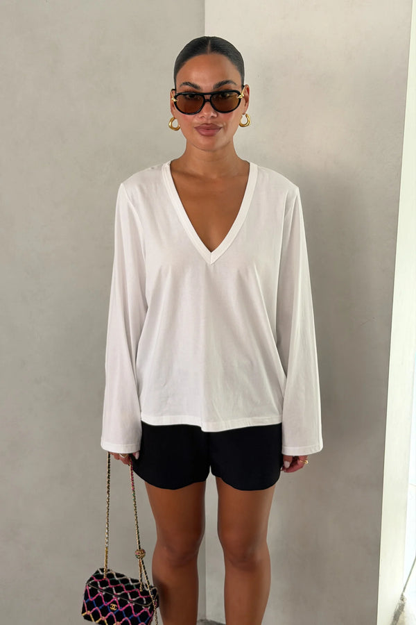 The Carter V Neck Long Sleeve Top by Sneaky Link is a breathable 100% cotton essential with a flattering V neckline and easy fit that pairs effortlessly with denim, tailoring, or layers.