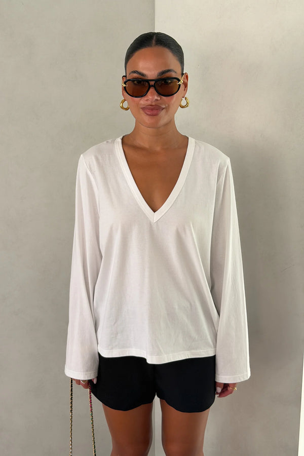 The Carter V Neck Long Sleeve Top by Sneaky Link is a breathable 100% cotton essential with a flattering V neckline and easy fit that pairs effortlessly with denim, tailoring, or layers.