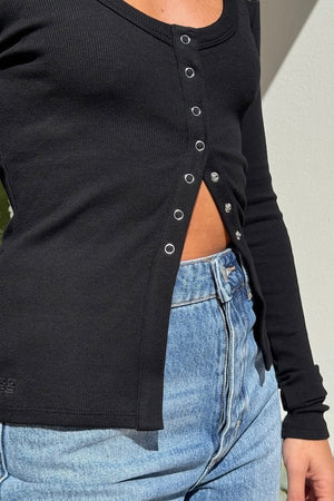 Lottie Long Sleeve Top Black by Sneaky Link – Soft cotton blend top with scoop neckline and snap button detail. Perfect for chic layering and viral winter style.