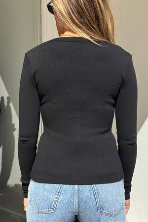 Lottie Long Sleeve Top Black by Sneaky Link – Soft cotton blend top with scoop neckline and snap button detail. Perfect for chic layering and viral winter style.