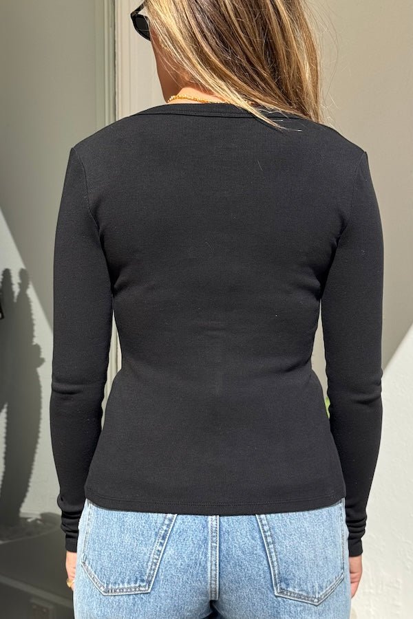 Lottie Long Sleeve Top Black by Sneaky Link – Soft cotton blend top with scoop neckline and snap button detail. Perfect for chic layering and viral winter style.