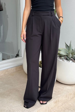 Kate Tailored Pant Black by Sneaky Link, high-waisted wide-leg pants crafted from luxe suiting fabric. Features waist tucks, pockets, and crossed belt loops for a modern, polished look.