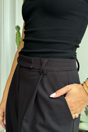Kate Tailored Pant Black by Sneaky Link, high-waisted wide-leg pants crafted from luxe suiting fabric. Features waist tucks, pockets, and crossed belt loops for a modern, polished look.