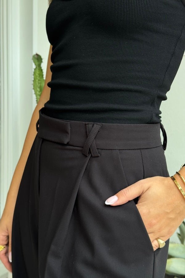 Kate Tailored Pant Black by Sneaky Link, high-waisted wide-leg pants crafted from luxe suiting fabric. Features waist tucks, pockets, and crossed belt loops for a modern, polished look.