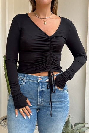 Daisy Long Sleeve Top Black by Sneaky Link – A cozy yet flirty top made from ultra-soft modal-spandex, featuring long sleeves, a V-neckline, and adjustable drawcord for a polished look.