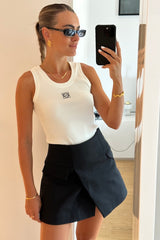 Sneaky Mini Skirt Black by Sneaky Link – A-line high-waisted mini with boned waist and flap pockets, perfect for day-to-night styling.