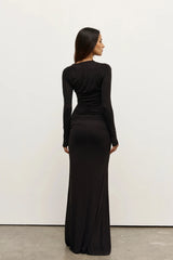 Inaya Maxi Dress Shadow by Bayse – asymmetrical maxi dress with ruched waist and long fitted sleeves.