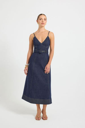 Indie Flared Midi in Indigo Denim by Pasduchas, a stretch denim midi with V-neckline, flared hem, contrast topstitching, and removable belt for tailored finish.
