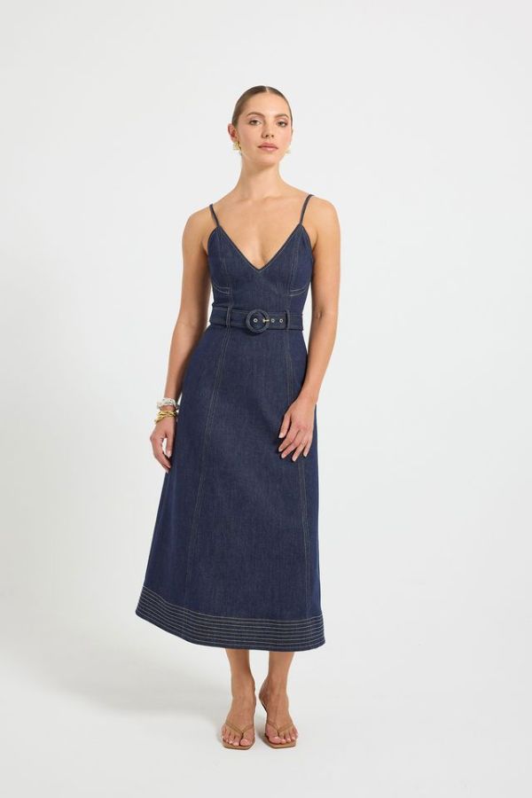 Indie Flared Midi in Indigo Denim by Pasduchas, a stretch denim midi with V-neckline, flared hem, contrast topstitching, and removable belt for tailored finish.

