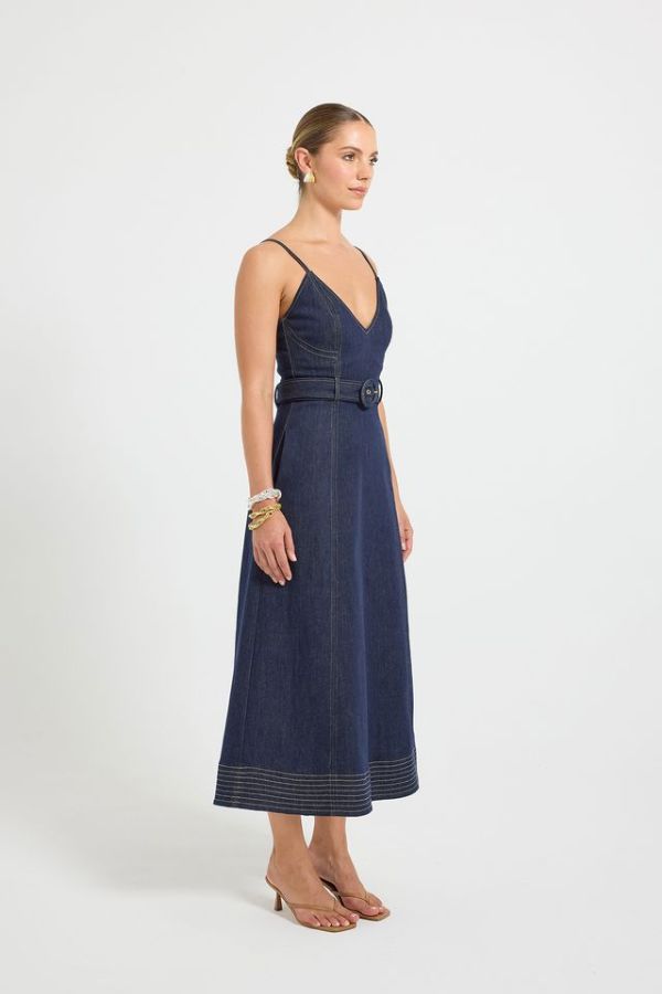 Indie Flared Midi in Indigo Denim by Pasduchas, a stretch denim midi with V-neckline, flared hem, contrast topstitching, and removable belt for tailored finish.
